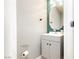 Chic half-bathroom featuring a stylish vanity with a modern faucet and a round mirror at 561 Fork Mesa Ct, Henderson, NV 89015
