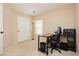 Neutral bedroom with carpet floors featuring a small desk with an office chair and a closet with sliding doors at 561 Fork Mesa Ct, Henderson, NV 89015