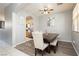Stylish dining room featuring a sleek ceiling fan, neutral decor, hardwood floors, and access to the kitchen at 561 Fork Mesa Ct, Henderson, NV 89015