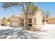 Charming two-story home with a well-maintained yard, desert landscaping, and large driveway and front porch at 561 Fork Mesa Ct, Henderson, NV 89015