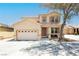 Inviting two-story home with a desert landscape, large driveway, and a charming front porch seating area at 561 Fork Mesa Ct, Henderson, NV 89015