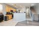 Open concept kitchen with wooden cabinets, stainless steel appliances and a breakfast bar at 561 Fork Mesa Ct, Henderson, NV 89015