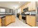 Well-lit kitchen with wood cabinets, stainless steel appliances, and granite countertops at 561 Fork Mesa Ct, Henderson, NV 89015