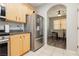 Bright kitchen featuring wood cabinets, stainless steel appliances, and an archway to the dining area at 561 Fork Mesa Ct, Henderson, NV 89015