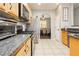 Bright kitchen with stainless steel appliances, stone countertops and view of the dining room at 561 Fork Mesa Ct, Henderson, NV 89015