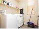 Bright laundry room equipped with a washer, shelf and a window providing natural light at 561 Fork Mesa Ct, Henderson, NV 89015