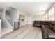 Bright and open living room with hardwood floors, comfortable seating, and a staircase at 561 Fork Mesa Ct, Henderson, NV 89015