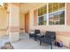 Inviting front porch with comfortable seating, decorative columns, and views of the surrounding neighborhood at 561 Fork Mesa Ct, Henderson, NV 89015