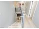 Bright staircase with gray railing that leads to a carpeted hallway and bedrooms on the upper level of the home at 561 Fork Mesa Ct, Henderson, NV 89015