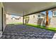 The covered back patio features a stone-tiled ground cover and minimal landscaping at 576 Foster Springs Rd, Las Vegas, NV 89148