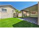 The backyard features artificial grass, desert landscaping and covered patio at 576 Foster Springs Rd, Las Vegas, NV 89148