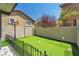 Backyard featuring artificial grass, desert landscaping and putting green at 576 Foster Springs Rd, Las Vegas, NV 89148