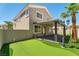 Exterior of home featuring a patio, desert landscaping, and putting green at 576 Foster Springs Rd, Las Vegas, NV 89148