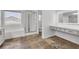 Bathroom featuring a tile floor, a soaking tub, and a glass shower at 576 Foster Springs Rd, Las Vegas, NV 89148