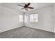 A bright bedroom with neutral carpet and two windows that let in natural light at 576 Foster Springs Rd, Las Vegas, NV 89148