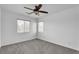 A bright bedroom with neutral carpet and two windows that let in natural light at 576 Foster Springs Rd, Las Vegas, NV 89148