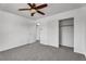 A bedroom with carpet and a ceiling fan and two closets, one with a hanging rack at 576 Foster Springs Rd, Las Vegas, NV 89148