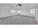 Airy primary bedroom with plush carpet and multiple windows at 576 Foster Springs Rd, Las Vegas, NV 89148