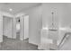 Upstairs hallway with neutral colored carpet and a hanging light fixture at 576 Foster Springs Rd, Las Vegas, NV 89148