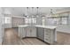 Open-concept kitchen with an island, stainless steel dishwasher, and living space at 576 Foster Springs Rd, Las Vegas, NV 89148