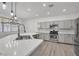 Bright kitchen features an island with marble countertops and stainless steel appliances at 576 Foster Springs Rd, Las Vegas, NV 89148