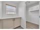 Well-organized laundry room featuring built-in cabinets and window at 576 Foster Springs Rd, Las Vegas, NV 89148