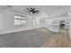 Open concept living room with ceiling fan and views of the kitchen and backyard at 576 Foster Springs Rd, Las Vegas, NV 89148