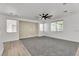 Cozy living area with gray carpet, geometric wall design, and natural light at 576 Foster Springs Rd, Las Vegas, NV 89148