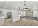 Open living space with a sleek kitchen, gray carpet and modern decor at 576 Foster Springs Rd, Las Vegas, NV 89148
