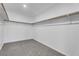Spacious walk-in closet with shelving, rods, and gray carpet flooring at 576 Foster Springs Rd, Las Vegas, NV 89148