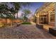 Spacious backyard with a modern fire pit, covered patio, and ample seating areas at 5823 Falling Stream Ave, Las Vegas, NV 89131