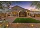 Beautiful backyard with an outdoor kitchen, artificial turf, and relaxing patio areas at 5823 Falling Stream Ave, Las Vegas, NV 89131