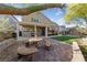Charming backyard patio featuring a custom stone table set and covered entertaining space at 5823 Falling Stream Ave, Las Vegas, NV 89131