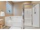 Clean and modern bathroom featuring a separate tub and shower with glass door at 5823 Falling Stream Ave, Las Vegas, NV 89131