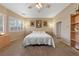 Neutral bedroom with natural light, ceiling fan, and framed art hung above the bed at 5823 Falling Stream Ave, Las Vegas, NV 89131