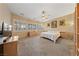 Spacious bedroom with neutral walls, carpet, and multiple windows offering ample natural light at 5823 Falling Stream Ave, Las Vegas, NV 89131