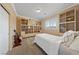 This bright bedroom has built in shelving and plantation shutters at 5823 Falling Stream Ave, Las Vegas, NV 89131