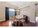 Dining room with hardwood floors, a modern chandelier, and seating for eight at 5823 Falling Stream Ave, Las Vegas, NV 89131