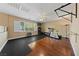 Spacious home gym with hardwood and rubber flooring plus exercise equipment at 5823 Falling Stream Ave, Las Vegas, NV 89131