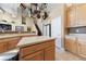 Bright kitchen with light wood cabinets, a center island, and hanging pot rack at 5823 Falling Stream Ave, Las Vegas, NV 89131