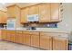 Well-equipped kitchen with light wood cabinets, modern appliances, and a tiled backsplash at 5823 Falling Stream Ave, Las Vegas, NV 89131