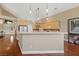 Spacious kitchen with light wood cabinets, a breakfast bar, and modern appliances at 5823 Falling Stream Ave, Las Vegas, NV 89131