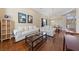 Open-concept living room with hardwood floors, elegant sofas, and stylish decor at 5823 Falling Stream Ave, Las Vegas, NV 89131