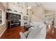 Bright living room with high ceilings, a fireplace, hardwood floors, and comfortable seating at 5823 Falling Stream Ave, Las Vegas, NV 89131