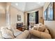 Living room with hardwood floors, large windows, and comfortable sofas at 5823 Falling Stream Ave, Las Vegas, NV 89131
