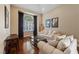 Living room featuring hardwood floors, large windows, comfortable sofas, and tasteful decor at 5823 Falling Stream Ave, Las Vegas, NV 89131