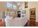 Bright living room with fireplace, hardwood floors, vaulted ceilings, and a view to the backyard at 5823 Falling Stream Ave, Las Vegas, NV 89131