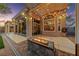 Beautiful outdoor patio featuring a modern fire pit and glass sliding doors to the home's interior at 5823 Falling Stream Ave, Las Vegas, NV 89131