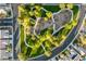 Aerial view of a neighborhood park, featuring winding walkways, playground, trees, and green spaces at 5823 Falling Stream Ave, Las Vegas, NV 89131
