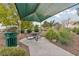 Relax at the community picnic area under a shaded canopy, surrounded by desert landscaping and lush greenery at 5823 Falling Stream Ave, Las Vegas, NV 89131